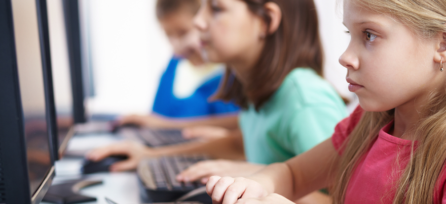 young children typing at computers